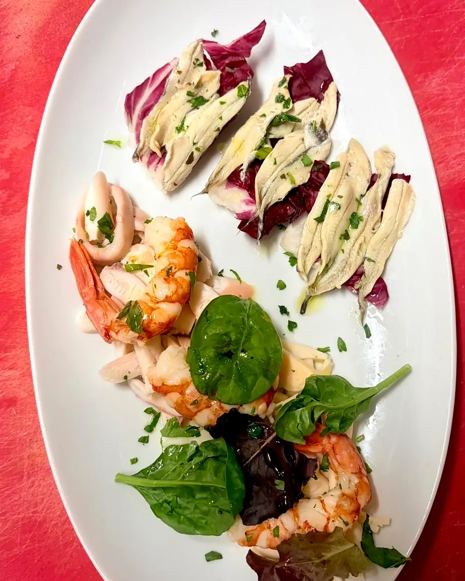 Seafood starter with marinated anchovies, prawns and squid